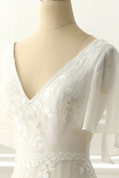 a white wedding dress on a mannequin