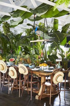 the instagram page on instagram shows an image of a dining room with tropical plants