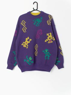 90s ski sweater in purple with funky monster figures by Le Jour Blanc. A bold purple ski sweater with a neon yellow, green and pink abstract monster pattern. This sweater features a super stretchy hem, a stretchy crew neck and cuffs. An awesome Le Jour Blanc label is stitched onto the back of the jumper. Made in France from a soft to touch heavy weight wool and acrylic blend.  Our recommended size: Large  Label says: Large Condition: Very good Material: 50% acrylic, 50% wool Measurements in inch Purple Fire Sweater, Oversized 90s Graphic Print Sweater, Retro Purple Winter Sweater, 90s Purple Winter Sweater, Multicolor Vintage Sweater With Graphic Print, Ski Sweater, Small Wardrobe, Pullover Sweater Men, Green Sweater