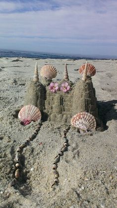 sand castle made with shells and seashells on the beach