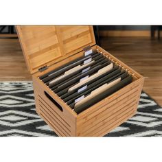 a wooden box filled with files on top of a rug