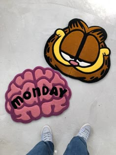 a person standing next to a rug with the words monday and a cartoon brain on it