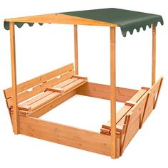 a wooden bed frame with a green canopy over it and two benches under the top