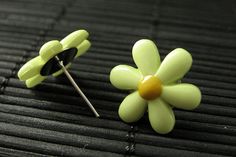 A  pair of cute little pale green daisy flowers with yellow centers have been set upon silver tone post earrings (no nickel) in this pair of handmade flower earrings that come with matching silver tone earring backs. Size: 16mm daisy flowers These earrings are available in different colors! http://etsy.me/1opqTav If you would like to order a larger quantity than what's offered in this listing, please contact me for availability! Stop by and visit http://stumblingonsainthood.etsy.com to see more Green Flower Earrings, Feminine Jewelry, Flower Stud Earrings, Earrings Flower, Holiday Gift Wrap, Flower Stud, Earrings Green, Green Flower, Flower Jewelry