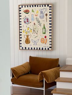 a brown chair sitting in front of a painting on the wall next to some stairs