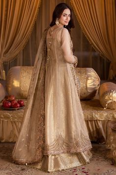 Pakistani Wedding Dress in Gold Open Gown Lehenga Style is a stunning attire that is an epitome of beauty and tradition. This stunning Pakistani Bridal Outfit is adorned with lavish designs, hand-crafted embellishments, and it comes in premium quality fabric, creating a lavish attire for the wedding. Pakistani Bridal Gown: Pakistani Bridal Gown in open style an alluring golden color and is beautifully embellished with the intricate designs and shimmering goldwork. Sequins, motifs, stones, and pe Bridal Gown Pakistani, Pakistani Bridal Gown, Gown Pakistani, Gown Lehenga, Wedding Pakistani, Pakistani Wedding Dress, Bridal Outfit, Lehenga Style, Gold Work