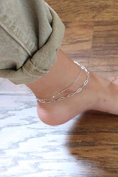 Upgrade your ankle game with our 2-row stainless steel paperclip anklet! Available in two stylish colors, this anklet is the perfect finishing touch to any outfit. Made with high-quality materials, it's sure to make a lasting impression. Don't miss out on adding this trendy piece to your jewelry collection! DETAILS: * Stainless steel, 18k gold PVD MEASUREMENTS: * Length: 9" + 1" inch extender CARING TIPS: * Avoid contact with water, sweat, lotions & perfumes as these can tarnish the jewelry * Keep jewelry clean and dry * We recommend using polishing cloths to restore the shine to your jewelry OTHER INFORMATION: * All items are packaged in elegant jewelry pouches * Have any questions? Feel free to contact us. We reply fast! MORE FROM US https://leycorjewelry.etsy.com Instagram: @leycorjewel Silver Chain Anklet, Anklet Silver, Anklet For Women, Simple Chain, Women Anklets, Gold Anklet, Double Chain, Chain Anklet, Anklet Bracelet