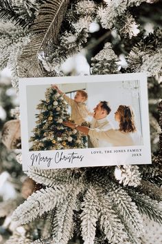 an ornament hanging from a christmas tree with a family photo on the top