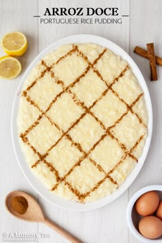 an image of food on a plate with lemons and cinnamon in the background that says arroz doce portuguese rice pudding