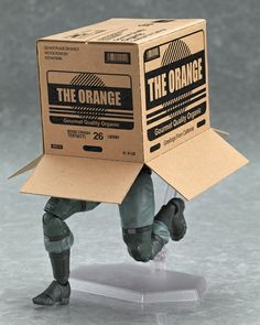 an action figure with a cardboard box on his head