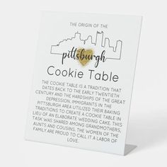 a white card with a gold heart in the center that reads, pittsburgh cookie table