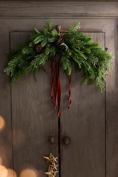 a christmas wreath hanging on the front door