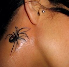 a woman's neck with a spider tattoo on her left side behind the ear