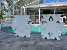 two large snowflakes sitting in front of a swimming pool