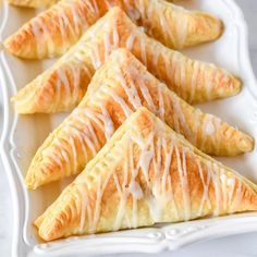 several pastries with icing on a white plate