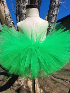 Sparkle, shimmer, twirl and spin, This tutu's where the fun begins, For dress up, play, or just because, All for the little girl you love. This bright and beautiful tutu is made with Emerald Green colored tulle. Our tutu band's are made from a crocheted material. They are quite stretchy and will fit from newborn up to a 24" waist. To measure start at the belly button and go around the waist. You may choose from 6" length to 13" length.  The shorter the length the fluffier it will be.   Here are Infant Tutu, Green Tutu, Tutu Birthday, Christmas Tutu, Kids Tutu, Ballerina Tutu, Toddler Tutu, Girls Skirts