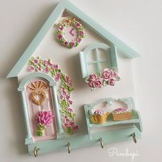 there is a doll house with pink flowers on the outside and green trimmings