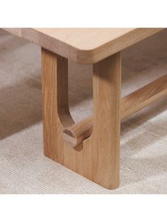 a wooden bench sitting on top of a carpeted floor