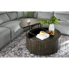 a living room with a couch, coffee table and sectional sofa in the corner on carpeted flooring