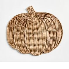 a woven pumpkin shaped basket on a white background