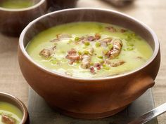 two bowls filled with soup on top of a table