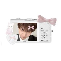 a small white camera with a pink bow on it's head and an image of a man in a tuxedo