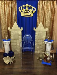 a blue and gold stage set up for a children's birthday party with decorations