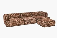 an animal print couch with ottomans on the bottom, and one foot in the middle