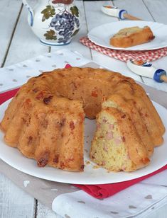 a bundt cake on a plate with one slice cut out