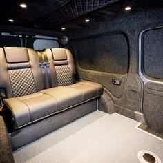 the inside of a vehicle with leather seats and grey carpeted flooring is shown