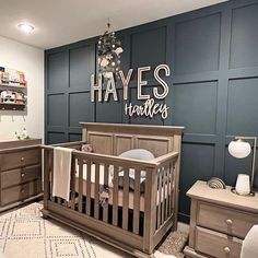 a baby's room with blue walls and wooden furniture