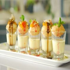 small desserts are lined up on a white platter, ready to be eaten