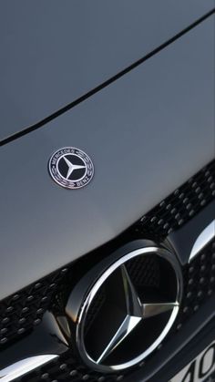 the front end of a mercedes car with its emblem on it's grills