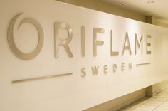 a sign that says oriflame is on the wall in front of it