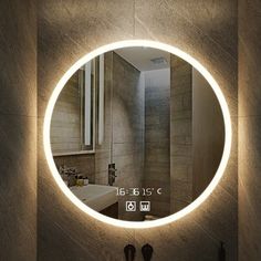 a bathroom with a round mirror on the wall above it and a sink in front of it