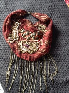 a close up of a piece of cloth with beads and chains hanging from it's sides