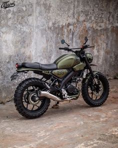 a motorcycle parked in front of a concrete wall