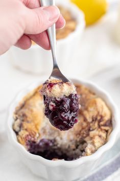 a spoonful of blueberry cobbler in a white bowl