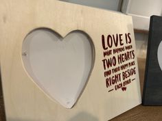 two wooden frames with hearts and words on them