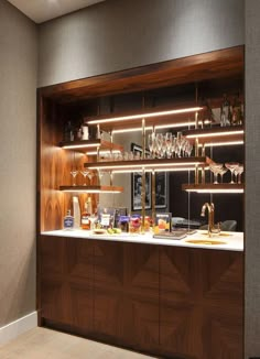 a kitchen with wooden cabinets and shelves filled with wine glasses