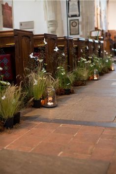 rows of pews with flowers and candles in them