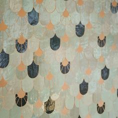 an abstract wall with gold and blue leaves on it's sides, hanging from the ceiling