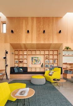 a living room filled with furniture and wooden walls