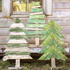 three wooden christmas trees sitting next to each other