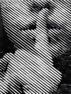 a black and white photo of a woman's face with lines in the background