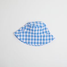 Introducing the Gingham Sunhat! Keep your little one looking stylish and shaded with this fun and fashionable cornflower blue baby sun hat, complete with checkered gingham print that your baby will love. Perfect for a day at the beach or a stylish stroll in the park. Shade in style! Fits ages 6 - 12 months Summer Plaid Bucket Hat, Casual Gingham Hats For Summer, Summer Gingham Hat With Curved Brim, Plaid Curved Brim Hat For Beach, Plaid Curved Brim Hat For The Beach, Summer Plaid Brimmed Hat, Plaid Hats For Summer Beach, Plaid Summer Beach Hat, Adjustable Plaid Hats For Beach