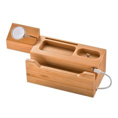 two wooden trays with one holding a magnifying glass and the other carrying an electronic device