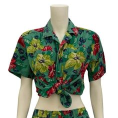 This bold 1980s green floral print top is part of a matching play set from Liz Wear by Liz Claiborne. I'm listing the pieces separately as not everyone wants a completely matching outfit. The top is 100% cotton and tagged a size small, but it is typical boxy oversized 80s top, so it's bigger in the bust and waist, but short - see measurements for details. It has removeable shoulder pads (velcro), buttons up the front with double buttons (two at each button hole spot) and has two large pockets on Green Printed Tropical Tops, Green Tropical Printed Tops, Beach Green Floral Print Set, Beach Green Floral Print Sets, Fitted Green Tops With Floral Print, Fitted Green Floral Print Tops, Green Hawaiian Top For Spring, Hawaiian Cotton Floral Print Tops, Spring Hawaiian Green Top