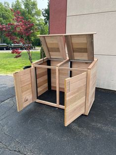 an open wooden box sitting on the side of a building