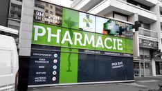 a large pharmacy sign on the side of a building